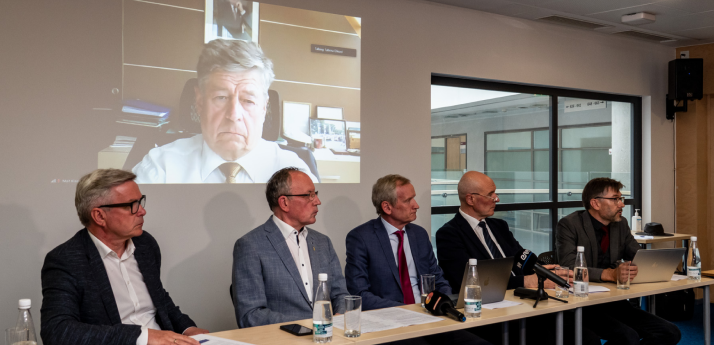 Rectors sitting in a meeting, each concentrating on listening to somebody.